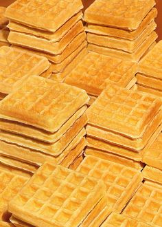 a pile of waffles sitting on top of each other in front of a brown table