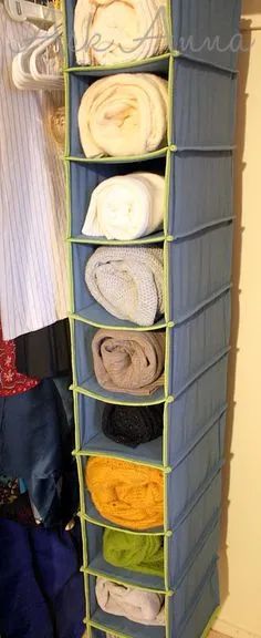 an over the door storage rack holds folded clothes