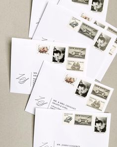 several envelopes with stamps on them sitting next to each other