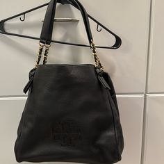 Tory Burch, Black Shoulder Bag With Three Inner Compartments, One With Zipper, Multiple Inside Side Pockets, And Tori Embossed Logo On Front Tory Burch Shoulder Bag, Tory Burch Bags, Black Shoulder Bag, Tory Burch Bag, Embossed Logo, Tory Burch, Shoulder Bags, Bag Lady, Shoulder Bag