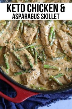 chicken and asparagus skillet in a red pan on a blue tablecloth