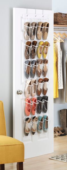 a shoe rack with shoes hanging on it in front of a white door and yellow chair