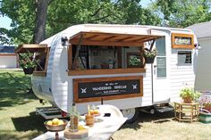 an old camper is converted into a mobile home bar for wine tasting in the back yard