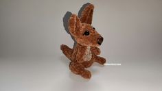 a brown stuffed animal sitting on top of a white table