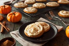 a table topped with cookies and pumpkins