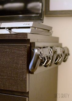 two video game controllers are sitting on top of a dresser