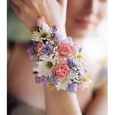 a woman wearing a bracelet with flowers on it