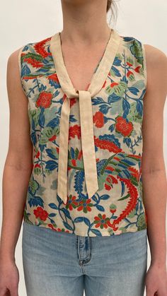 "This rare 1920s Japanese export raw silk blouse or top features a lovely design of flowers and leaves with a bird with large tail feathers to the back. There are two silk ties to the front which can be worn loose or tied. It is labelled 'Made in Japan' to the inside of the neck.  When laid flat the measurements are: Length: 21\" inches From underarm to underarm across: 17.5\" inches Across the bottom edge: 18.25\" inches It is in excellent condition, the colours have remained fresh and bright and it looks to have hardly been worn. There is a little wear to the edge of the silk at the centre top front, you can see this in the photos. Please see all the images and zoom in for details, further photos are available on request." Vintage Silk Top With Floral Print, Japanese Blouse, Traditional Silk Top With Floral Print, 1920s Blouse, 1940s Coat, Liberty Scarf, Scarf Top, Raw Silk, Silk Ties