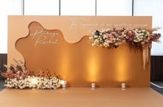 an arrangement of flowers and candles on a table with a sign that says the wedding of mr and mrs