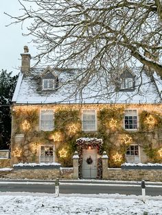 a house covered in christmas lights and snow