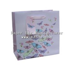 a white paper bag with butterflies on the front and bottom, is shown in this image