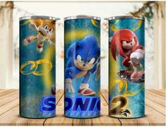 three sonic the hedgehog cans on a wooden table