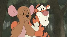 winnie the pooh and tigger hugging each other in front of some trees with their mouths open