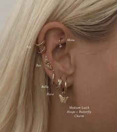 a woman with blonde hair wearing three different types of ear piercings on her ears