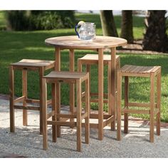 three wooden stools sit around a small table