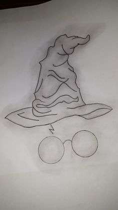 a drawing of a wizard's hat and goggles on top of a sheet of paper