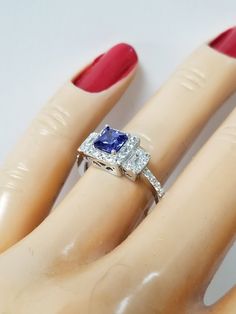 "Thanks for shopping our vintage estate store. We tend to sell well below wholesale and truly hope you enjoy all of our items. Many of the items are one of a kind, so please enjoy scrolling through the pictures and hopefully something will catch your eye. Brown spots are from camera. Estate Sterling Silver 925 lab created princess cut 1/2ct tanzanite cz 1cts diamonds ring. This is a custom made item from our shop, meaning we added the gem to the setting. Ring size: please select a size Setting: Vintage Gia Certified Sapphire Ring Gift, Gia Certified Princess Cut Sapphire Ring Gift, Classic Princess Cut Sapphire Ring For Anniversary, Vintage Cubic Zirconia Sapphire Ring For Anniversary, Princess Cut Sapphire Ring With Center Stone For Anniversary, 1ct Diamond Ring, Nouveau Art, Tanzanite Ring, Diamonds Ring