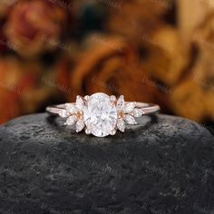 a white diamond ring sitting on top of a rock