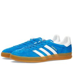 adidas reintroduces its iconic Gazelle Indoor trainers from 1979 this season. Arriving in a blue colourway, they have all the details that football fans, indie rockers and sneakerheads have loved for decades. From its soft suede and a durable leather lining- which comes together on a gum rubber outsole. Then, they’re signed off at the side wall with its signature Three Stripes..Suede Uppers.Rubber Outsole.Three Stripes on Side Wall.Trefoil on Tongue and Heel Tab Adidas Gazelle Indoor, Sport Shoes Men, Side Wall, Outdoor Men, Adidas Gazelle, Mens Sportswear, Sneaker Collection, Football Fans, Personal Shopping