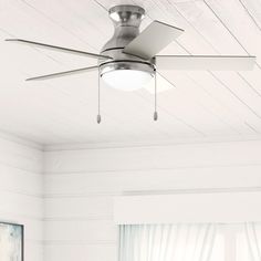 a ceiling fan in a room with white walls