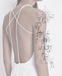 the back of a woman's shoulder with flowers on it