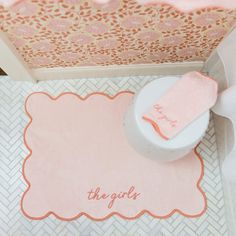 a pink and white bathroom rug with the word thank written on it next to a toilet