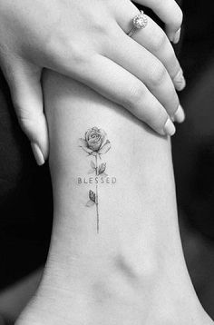 a woman's foot with a rose tattoo on it