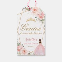 a pink and gold princess name tag with roses on the front, and a crown on the back