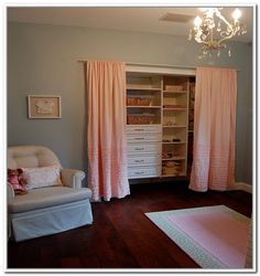 a baby's room with pink curtains and white furniture