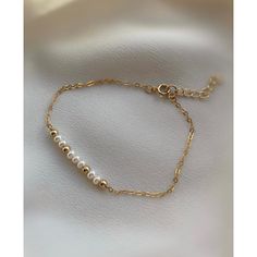 **DESCRIPTION** Delicate gold filled bracelet with freshwater pearl beads. Individually selected high quality gemstones make the bracelet truly special and one of a kind. The delicate and minimalist design goes well with both casual and sophisticated looks. Wear it by itself or stacked up with other minimalist bracelets available at the shop. **MATERIALS** - 14kt gold filled chain, 14kt gold filled clasp and chain extender (1 inch) - Freshwater pearl beads (approx. 3mm x 2mm) **PACKAGING** All o Gold Pearl Bracelet With Adjustable Chain For Everyday, 14k Gold Filled Bracelet With Pearl Chain As Gift, Everyday Pearl Chain Bracelet In Gold, 14k Gold Filled Pearl Chain Bracelet Gift, Everyday Gold Pearl Chain Bracelet, Gold Pearl Chain Bracelet With Adjustable Chain, Classic Gold Chain Bracelet With Pearls, Classic Gold Pearl Chain Bracelet, Gold Adjustable Pearl Bracelet