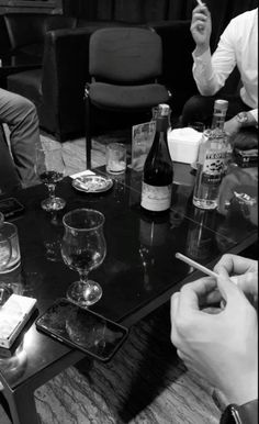 a group of people sitting around a table with wine glasses