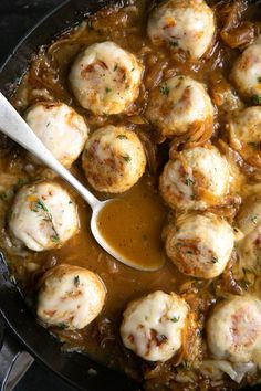 a skillet filled with meatballs and gravy