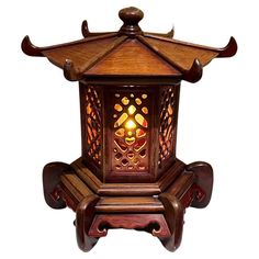 a wooden lantern with an intricate design on it