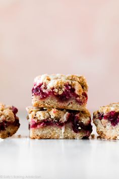 three pieces of dessert are stacked on top of each other with crumbled toppings