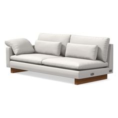 a white couch sitting on top of a wooden frame