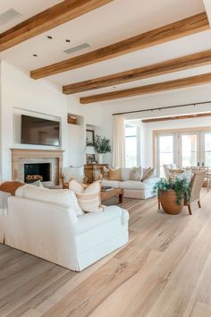 a living room filled with furniture and a fire place in the middle of a room