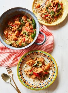 two bowls filled with food on top of a table