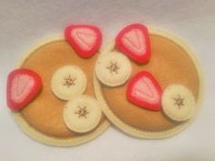 a close up of some food on a white tablecloth with red and pink decorations