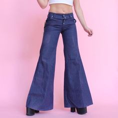 Vintage 70s jeans bell bottoms wide leg Dark wash denim bell bottom flare low rise hip higher hippie boho jeans with snap button fly NWT  FREE US SHIPPING  Label: Turtle Bax Made in USA Low cut Turtle bax Size 7/8 fits like 2 see measurements  100% cotton, no stretch  Overall great vintage condition, has fading on side of one leg from being folded in storage since 70s, more noticeable in pics due to my studio lights than it is in person Cool label patch on back pocket Big belt loops throughout  Silver snaps and button accents  Two pockets in front and back Very cute leather branding patch on the back pocket  Super wide flared out leg 🌈 MEASUREMENTS 🌈 Waist: 29" (sits low) Rise: 8.75" in front 11.5" in back Hips: 36"  Thigh at top: 9.75" flat  Inseam: 34" Bell opening: 30" Model is 5'4" w Vintage Flare Jeans With Pockets, 1970s Style Full Length Flare Jeans, Vintage High-rise Flare Jeans With Pockets, Cheap Vintage Full-length Flare Jeans, Jeans Bell Bottoms, Big Belt, 70’s Panel Jeans, 70s Jeans, Boho Jeans