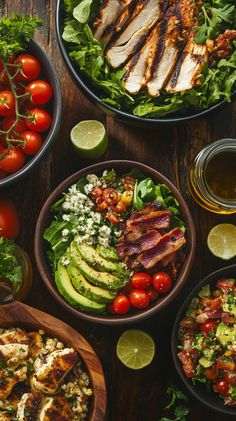 several plates of food on a table with limes, tomatoes and avocado