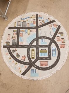 a round rug with cars and buildings on it