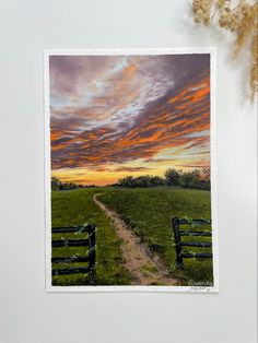 a painting of a sunset over a green field