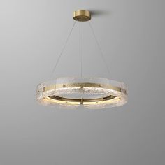 a circular chandelier hanging from a ceiling in a room with grey walls and flooring