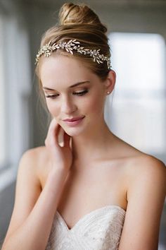 a woman in a wedding dress wearing a headband