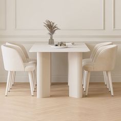 two white chairs and a table in a room