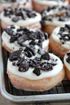 there are many doughnuts with white frosting and chocolate chips