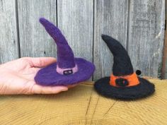 two handmade witches hats sitting on top of a wooden table