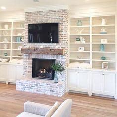 a living room filled with furniture and a flat screen tv mounted on a wall above a fireplace