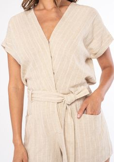 A classic short-sleeve bohemian short romper in a neutral stripe. Linen stripe Short cuffed sleeve Surplice v-neckline Concealed snap button-front top Button front shorts Hook & bar closure at the waist Half-elastic waist at the back Adjustable tie waist Side pockets Short romper Ready to romp? Our classic short romper is designed in a soft neutral stripe. Featuring short cuffed sleeves, an adjustable tie waist belt, and essential side pockets. We love to pair this Summer style with a lace-up sa Striped Short Sleeve Jumpsuits And Rompers For Summer, Beach Short Sleeve Jumpsuits And Rompers With Button Closure, Beach-ready Short Sleeve Jumpsuits With Button Closure, Striped Short Sleeve Jumpsuits And Rompers For Beach, Beige Short Sleeve Jumpsuits And Rompers For Vacation, Casual Striped V-neck Jumpsuits And Rompers, Bohemian Shorts, Short Romper, Boho Romper