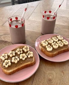 two pink plates topped with slices of toast covered in banana toppings next to each other